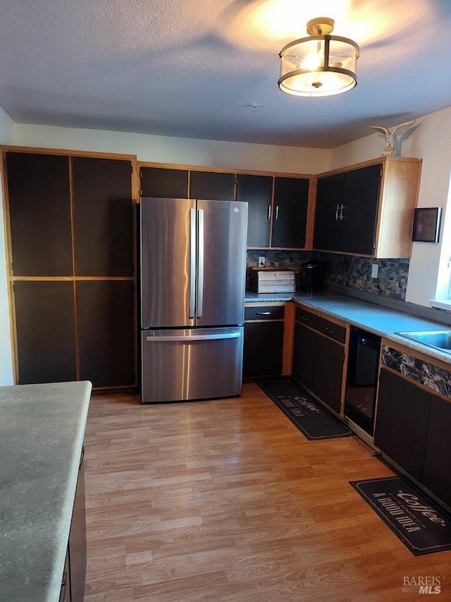 1142 Pear Tree Ln, Napa, CA 94558 - kitchen featuring freestanding refrigerator, light wood-style flooring, backsplash, and dishwasher