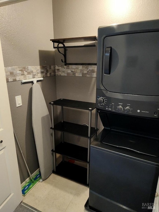 1142 Pear Tree Ln, Napa, CA 94558 - clothes washing area with stacked washing machine and dryer and tile patterned floors