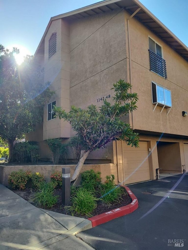 1142 Pear Tree Ln, Napa, CA 94558 - view of building exterior with an attached garage and asphalt driveway