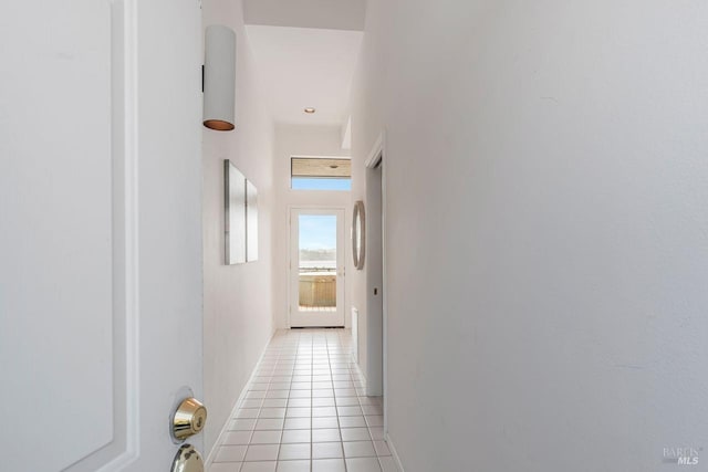 hall with light tile patterned floors