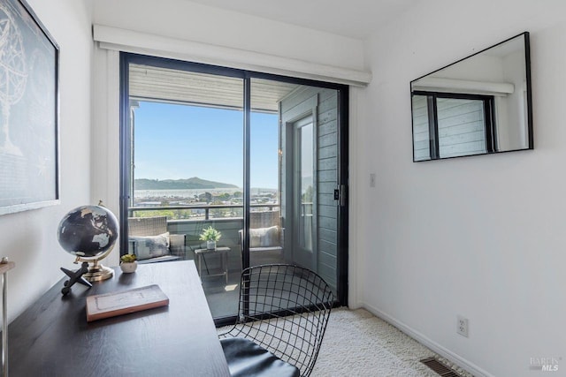 interior space with a mountain view and carpet flooring