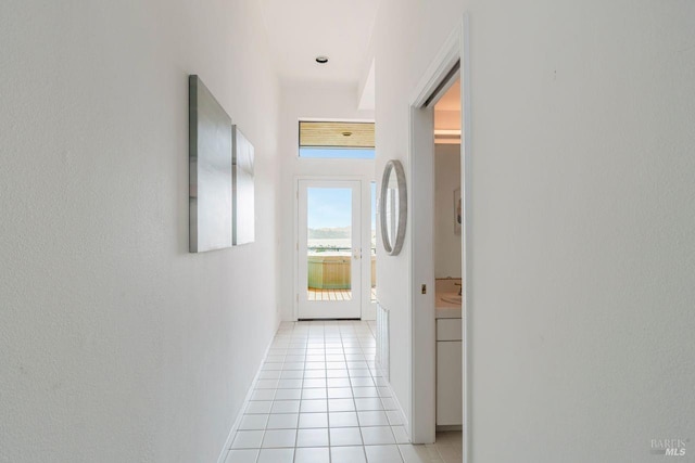 corridor featuring light tile patterned flooring