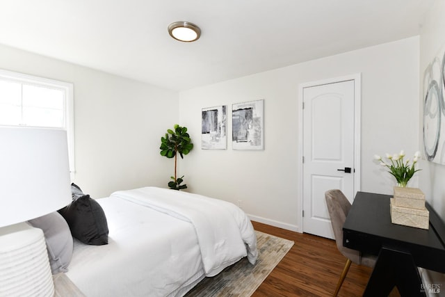 bedroom with dark wood-type flooring