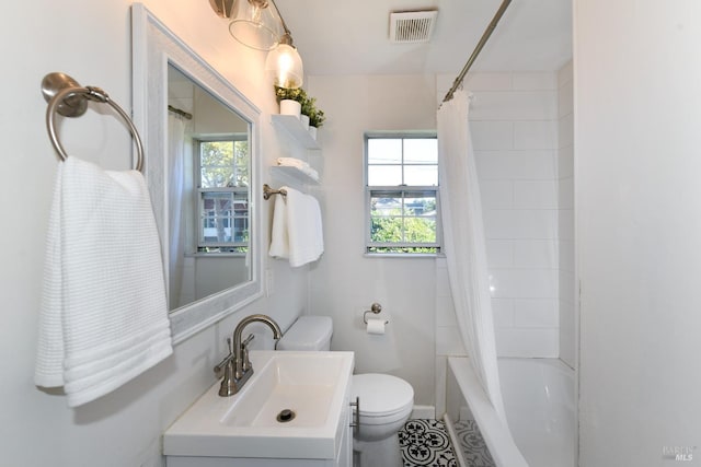 full bathroom featuring vanity, shower / bath combo, and toilet