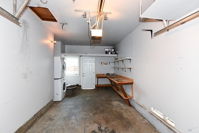 garage with a garage door opener and stacked washer / drying machine