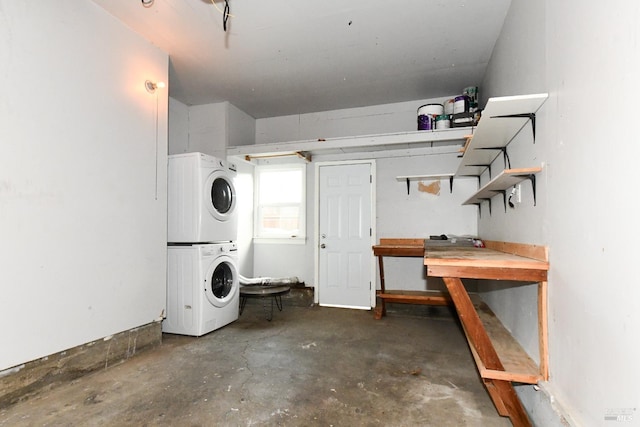 clothes washing area featuring stacked washer / drying machine