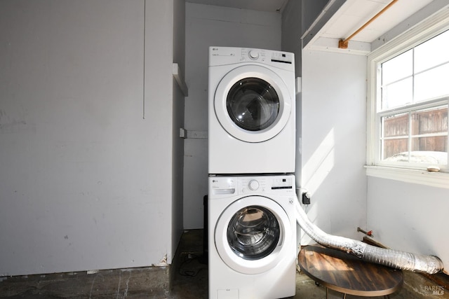 clothes washing area featuring stacked washer / drying machine