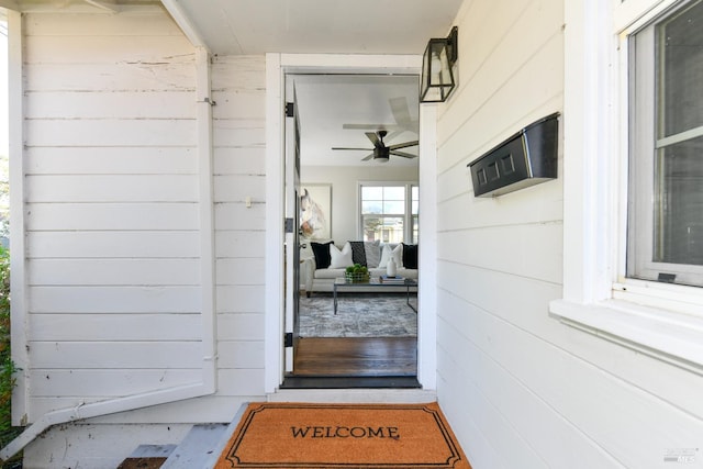 view of exterior entry with ceiling fan