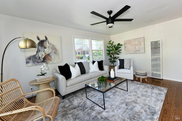 living room featuring dark hardwood / wood-style flooring and ceiling fan