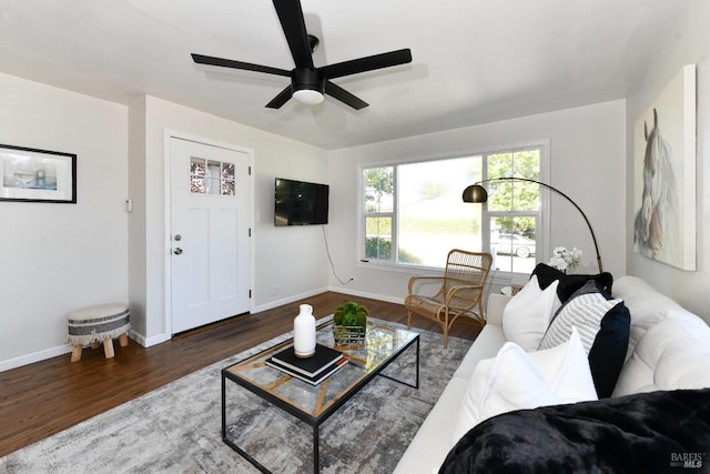 living room with ceiling fan and dark hardwood / wood-style flooring