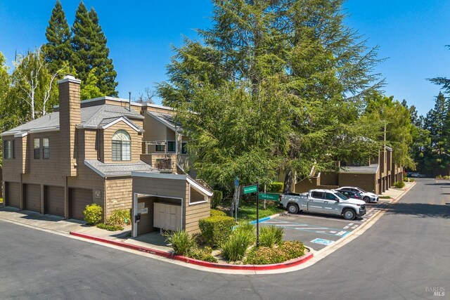 view of front of property with a garage and a balcony