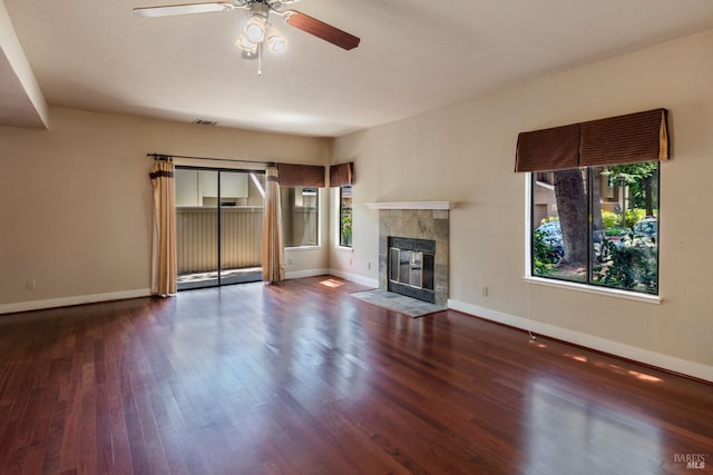 unfurnished living room featuring hardwood / wood-style flooring and a tile fireplace