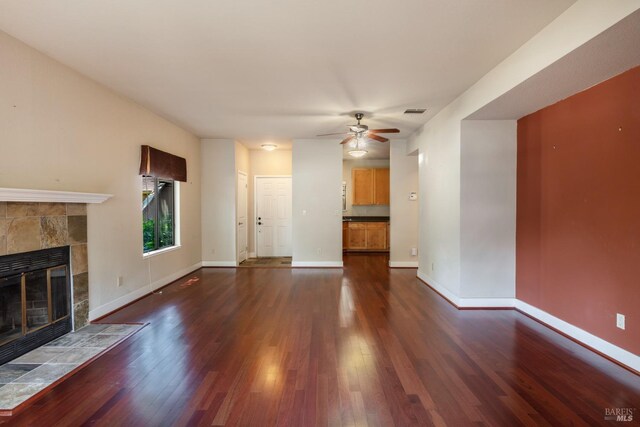 kitchen with dark wood-type flooring, black appliances, light brown cabinets, and sink