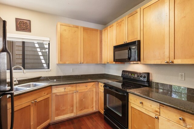 kitchen with sink, dark hardwood / wood-style floors, light brown cabinetry, and black appliances