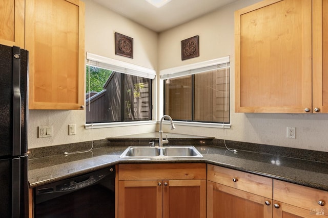 kitchen featuring dark stone counters, sink, and black appliances