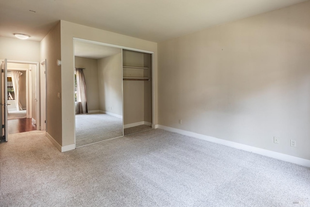 unfurnished bedroom featuring a closet and carpet flooring