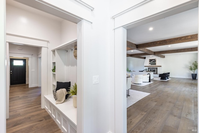 mudroom with beam ceiling and wood-type flooring