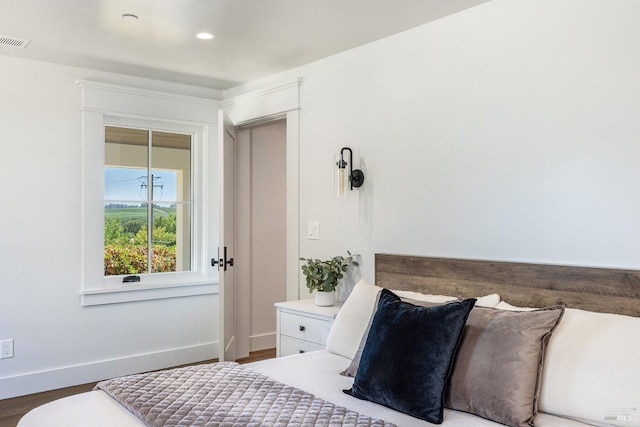 bedroom with hardwood / wood-style floors