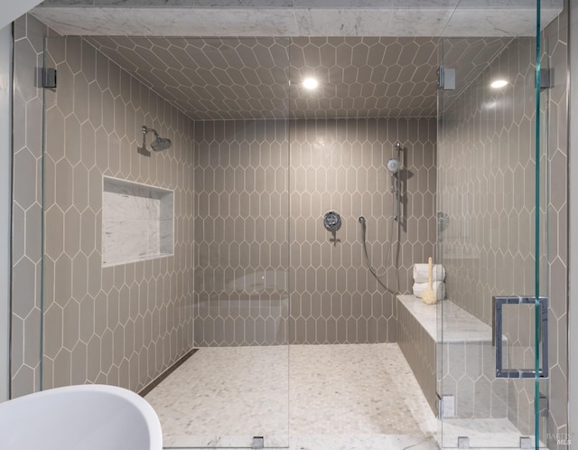 bathroom featuring separate shower and tub