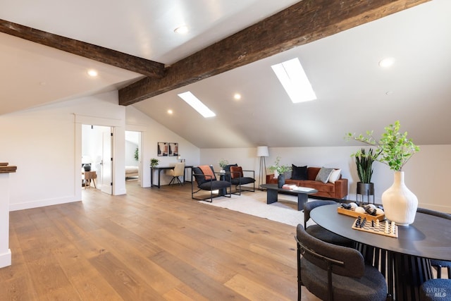 interior space featuring lofted ceiling with skylight and hardwood / wood-style floors