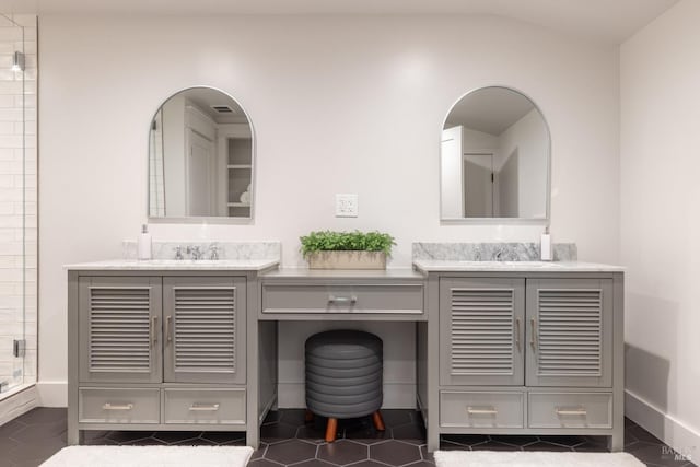 bathroom with lofted ceiling, a shower with door, and vanity