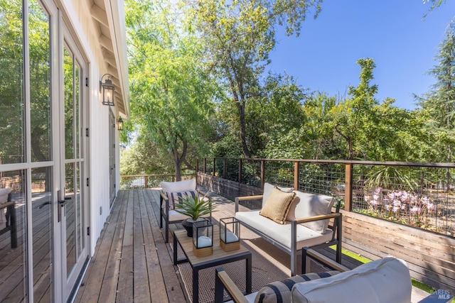 wooden deck with an outdoor living space