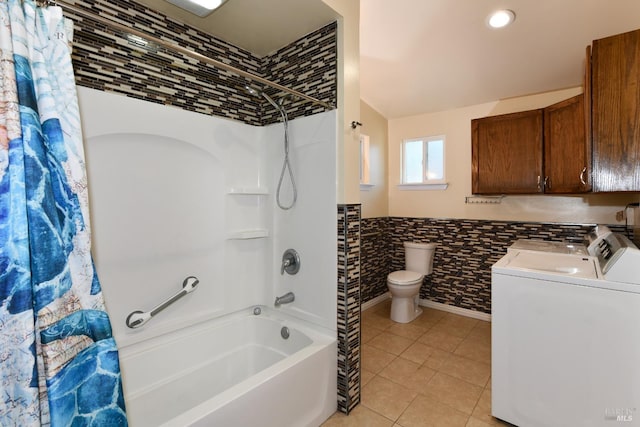 full bathroom with washing machine and clothes dryer, toilet, shower / bath combo with shower curtain, tile walls, and vanity