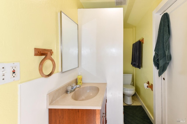 bathroom featuring vanity and toilet