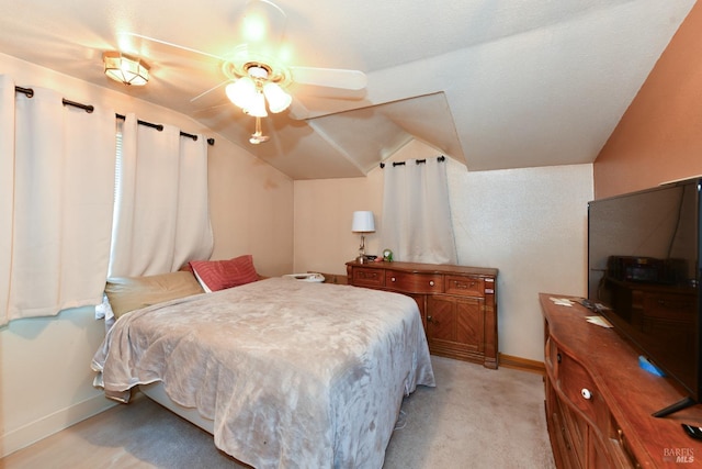 carpeted bedroom featuring ceiling fan and lofted ceiling