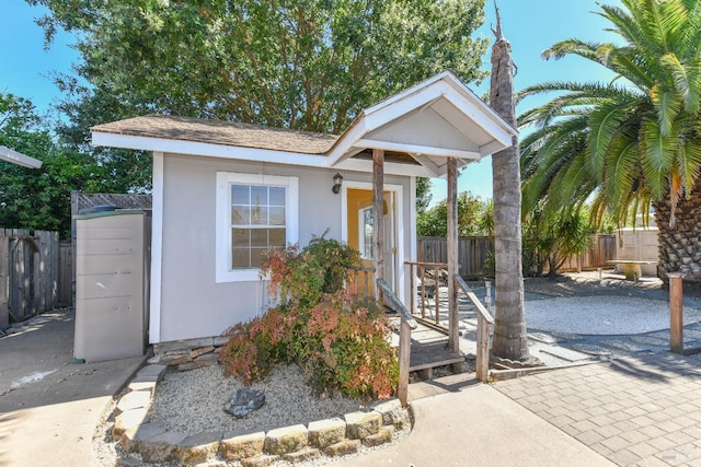 view of front facade with a shed and a patio