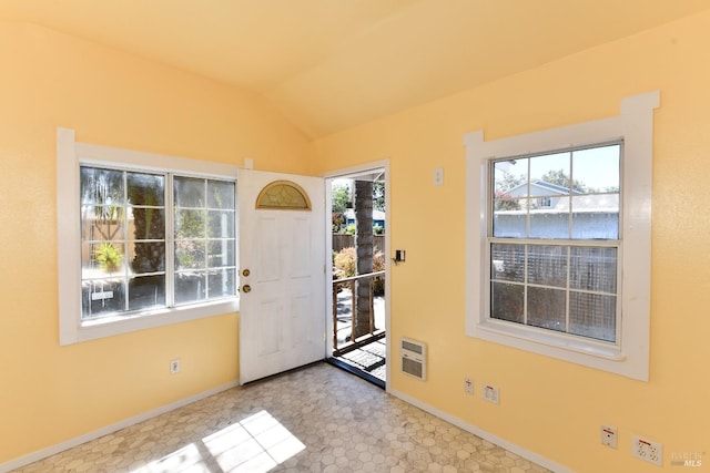 doorway to outside featuring heating unit and vaulted ceiling