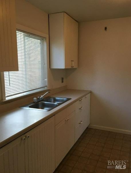 kitchen with sink and tile patterned flooring