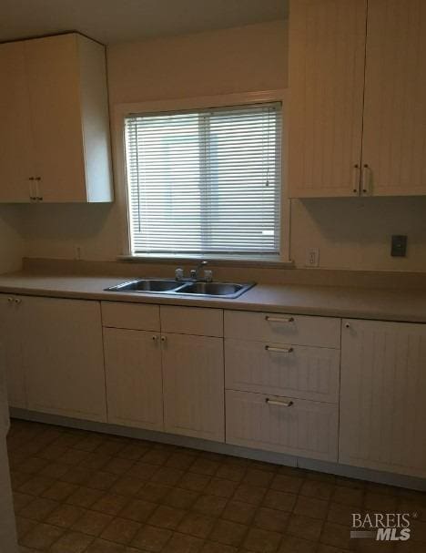 kitchen with light tile patterned flooring and sink