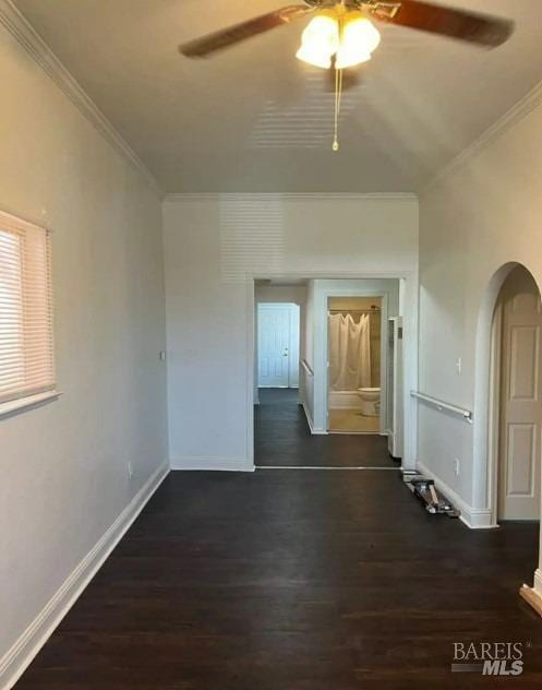 spare room with dark hardwood / wood-style floors, crown molding, and ceiling fan