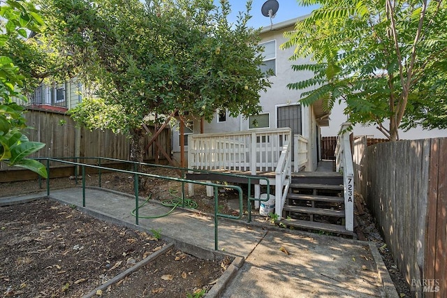 rear view of property with a patio and a deck