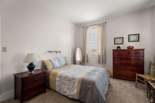 bedroom featuring baseboards and light colored carpet