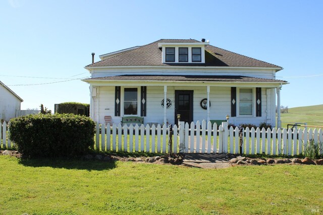 bungalow-style house featuring a porch, a front yard, and a fenced front yard