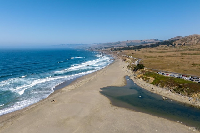 property view of water featuring a mountain view and a view of the beach