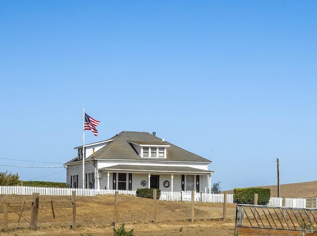 view of front facade featuring fence private yard