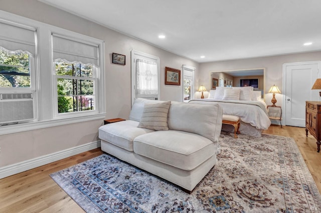 bedroom featuring light hardwood / wood-style floors and cooling unit