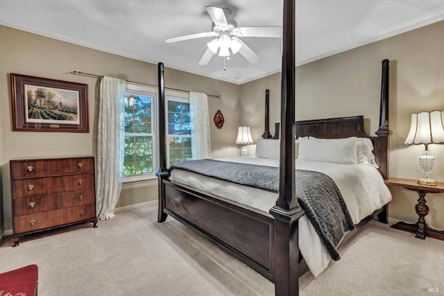 bedroom with light colored carpet, crown molding, and ceiling fan