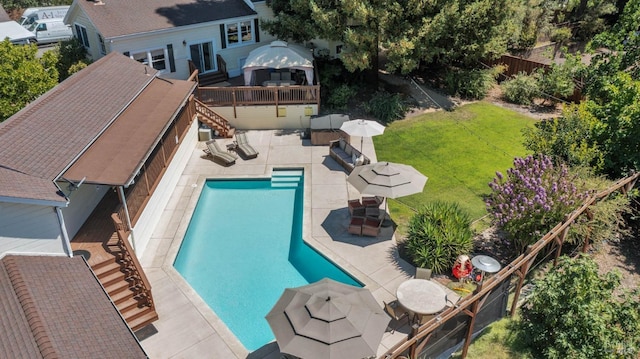 view of swimming pool featuring a patio and a yard