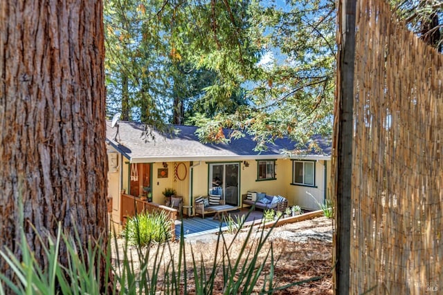 back of house with a wooden deck and an outdoor hangout area