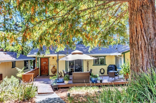 back of house featuring a wooden deck