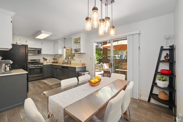 dining room with sink and dark hardwood / wood-style flooring