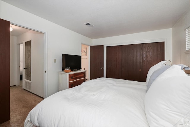 carpeted bedroom with a closet