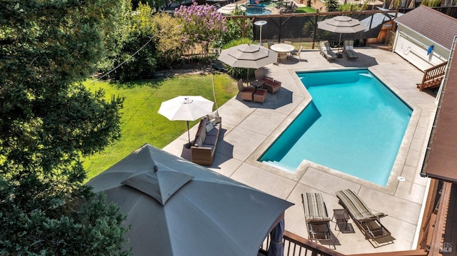 view of pool featuring a patio and a lawn