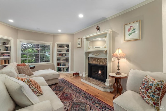 living room featuring ornamental molding, a fireplace, and hardwood / wood-style floors