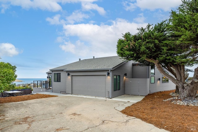 view of side of property with a water view and a garage