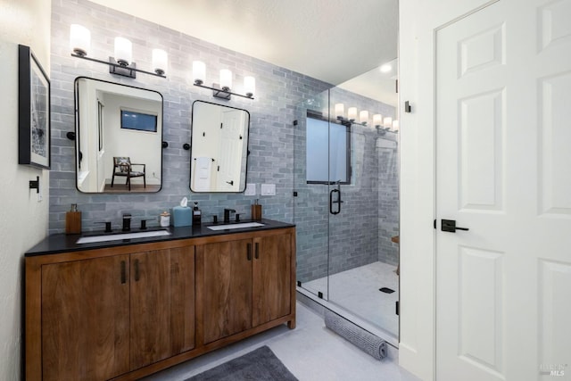 bathroom with tasteful backsplash, vanity, and a shower with shower door